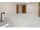 Spacious basement features clean tile flooring, neutral paint, and access doors for storage or utilities at 127 Roe Hampton Ln Ln, Stone Mountain, GA 30087