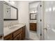 Bathroom with wood cabinets, bright lighting, and dual vanities provide ample space and functionality at 127 Roe Hampton Ln Ln, Stone Mountain, GA 30087