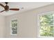 Bedroom with neutral-toned walls and bright natural lighting shines through the windows at 127 Roe Hampton Ln Ln, Stone Mountain, GA 30087