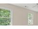 A bedroom with neutral-toned walls and bright natural lighting shines through the windows at 127 Roe Hampton Ln Ln, Stone Mountain, GA 30087