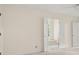 Bright bedroom with a ceiling fan and french doors, creating an inviting space for rest and relaxation at 127 Roe Hampton Ln Ln, Stone Mountain, GA 30087