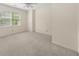Cozy bedroom with natural lighting, neutral carpet, and a ceiling fan at 127 Roe Hampton Ln Ln, Stone Mountain, GA 30087