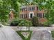 Charming brick home with black shutters, mature trees, and beautiful landscaping at 127 Roe Hampton Ln Ln, Stone Mountain, GA 30087