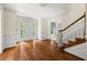 Bright foyer featuring a herringbone floor, staircase, and classic white trim at 127 Roe Hampton Ln Ln, Stone Mountain, GA 30087