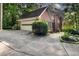 Spacious driveway leading to a two-car garage, framed by mature trees and meticulous landscaping at 127 Roe Hampton Ln Ln, Stone Mountain, GA 30087