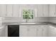 Kitchen features white cabinets and a view to the backyard at 127 Roe Hampton Ln Ln, Stone Mountain, GA 30087