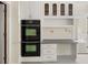 Bright kitchen features double ovens and a built-in desk, providing a functional and stylish space at 127 Roe Hampton Ln Ln, Stone Mountain, GA 30087