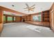 Cozy living room featuring built-in bookshelves, fireplace, and sunlit windows at 127 Roe Hampton Ln Ln, Stone Mountain, GA 30087