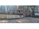 Charming brick home featuring a manicured lawn, white picket fence, and mature trees at 2289 Addison Rd, Marietta, GA 30066