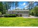 Spacious backyard featuring a deck, two-car garage, and lush greenery at 3131 Garden Lane Dr, Marietta, GA 30062