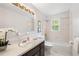 Well-lit bathroom features an elegant vanity, bathtub with shower, and a bright window at 3131 Garden Lane Dr, Marietta, GA 30062