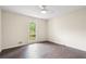 Bright bedroom features hardwood floors, neutral walls, ceiling fan and a sun-filled window view at 3131 Garden Lane Dr, Marietta, GA 30062