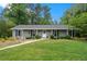 Well-maintained home with gray siding, black shutters, and lush front lawn at 3131 Garden Lane Dr, Marietta, GA 30062