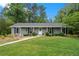Charming single-story home with well-manicured lawn and gray siding at 3131 Garden Lane Dr, Marietta, GA 30062