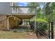 Backyard patio area with brickwork and a fenced in area underneath the deck above at 3131 Garden Lane Dr, Marietta, GA 30062