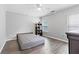 Bedroom with neutral gray walls, wood-look floors, ceiling fan, and two windows at 930 Silver Lake Dr, Acworth, GA 30102