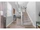 Bright foyer featuring a staircase, light wood floors, and ample natural light from tall windows at 930 Silver Lake Dr, Acworth, GA 30102