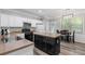 Well-lit kitchen featuring an island, stainless steel appliances, and an adjacent dining area at 930 Silver Lake Dr, Acworth, GA 30102