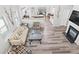 Open-concept living space with a fireplace, hardwood floors, and a view to the kitchen at 930 Silver Lake Dr, Acworth, GA 30102