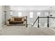 Cozy upstairs living area with carpet, a comfortable couch, and natural light from nearby windows at 930 Silver Lake Dr, Acworth, GA 30102
