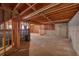 Unfinished basement with exposed framing and a concrete floor, offering potential at 11575 Wildwood Springs Dr, Roswell, GA 30075