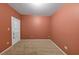 This empty bedroom features neutral paint, carpet, and a door with a window at 11575 Wildwood Springs Dr, Roswell, GA 30075
