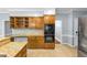 Kitchen with granite countertops, stainless steel appliances, tile flooring and wooden cabinetry at 11575 Wildwood Springs Dr, Roswell, GA 30075