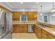 Kitchen featuring stainless steel appliances, granite countertops, tiled flooring, and wooden cabinetry at 11575 Wildwood Springs Dr, Roswell, GA 30075
