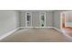 Bright living room featuring neutral walls, carpet, and bright windows at 11575 Wildwood Springs Dr, Roswell, GA 30075