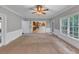 Living room with a view to the kitchen and large, bright windows at 11575 Wildwood Springs Dr, Roswell, GA 30075