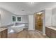 Luxurious bathroom with a freestanding tub, glass shower, and stylish vanities at 11575 Wildwood Springs Dr, Roswell, GA 30075