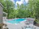 Inviting community pool with ample lounge chairs and well-maintained surrounding area at 11575 Wildwood Springs Dr, Roswell, GA 30075