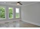 Bright bedroom with hardwood floors, a ceiling fan, and large windows with a green treeline at 293 White St # 2, Marietta, GA 30060