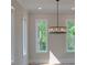Bright dining room with designer chandelier and three windows with natural views at 293 White St # 2, Marietta, GA 30060