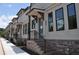 Modern townhome exterior with brick base, beige siding, black trim, and covered front entry at 293 White St # 2, Marietta, GA 30060