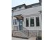 Charming townhouse entrance with brick stairs, black railing, and stylish front door at 293 White St # 2, Marietta, GA 30060