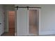 A main bedroom with barn door leading to bath and separate door to the walk in closet at 293 White St # 2, Marietta, GA 30060