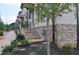 Close-up of townhouse facades with brick stairs, landscaping and covered entrances at 293 White St # 2, Marietta, GA 30060
