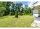 Expansive backyard featuring lush greenery and mature trees, offering privacy and a serene outdoor space at 297 Northgate Trce, Roswell, GA 30075