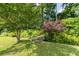 Picturesque backyard scene with a charming wooden bridge surrounded by lush trees and vibrant foliage at 297 Northgate Trce, Roswell, GA 30075