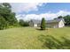 Wide shot of the backyard, showcasing the generous lawn space and landscaping around the house at 297 Northgate Trce, Roswell, GA 30075
