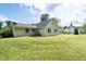 Spacious backyard with green lawn showcases the side and back of the house at 297 Northgate Trce, Roswell, GA 30075