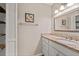 Bathroom featuring single sink vanity with granite top, mirror and open shelving at 297 Northgate Trce, Roswell, GA 30075