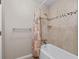 Neutral bathroom featuring a shower with tub, tile walls, and neutral shower curtain at 297 Northgate Trce, Roswell, GA 30075