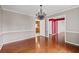Dining room featuring hardwood floors, gray walls, white trim, and a chandelier over the dining space at 297 Northgate Trce, Roswell, GA 30075