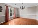 Dining room with hardwood floors, gray walls, white trim, and a chandelier over the dining space at 297 Northgate Trce, Roswell, GA 30075