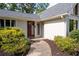 Close up of front door with mature landscaping including walkway lined with dark mulch and green shrubs at 297 Northgate Trce, Roswell, GA 30075