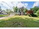 Ranch-style house with a stone chimney, a two-car garage and well-manicured lawn and mature landscaping at 297 Northgate Trce, Roswell, GA 30075