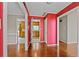 View from a hallway with hardwood floors looking into the kitchen with wood cabinets and granite countertops at 297 Northgate Trce, Roswell, GA 30075