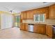 Kitchen with wood cabinets, stainless steel appliances, and ceramic tile floor leading to sliding glass doors at 297 Northgate Trce, Roswell, GA 30075
